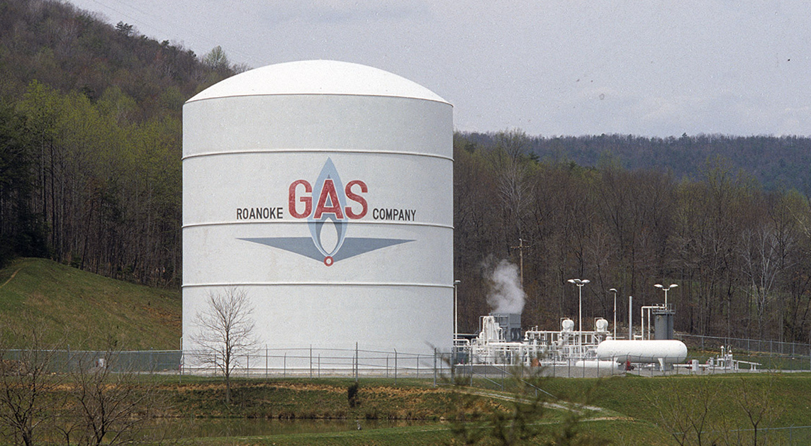 A large gas storage tank with the Roanoke Gas Company logo on the side of it.